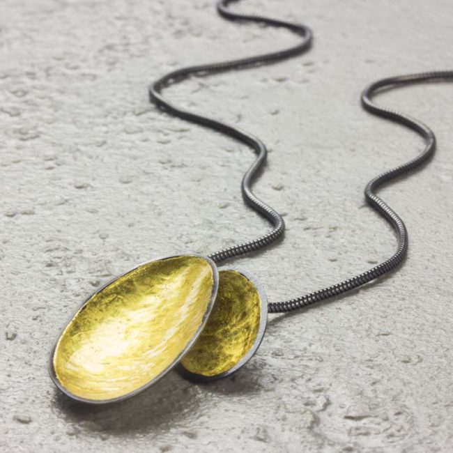 Two leaf silver necklace with yellow gold leaf