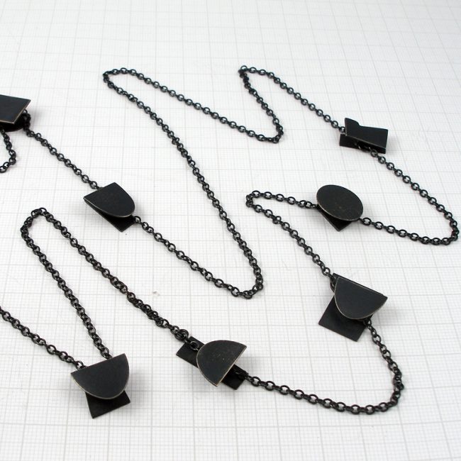 Long oxidised silver 8 shapes necklace by Annabet Wyndham
