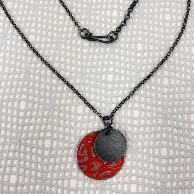 Alyssa disc pendant in red aluminium and oxidised silver, by Penny Warren