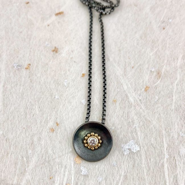 Oxidised silver disc pendant with white diamond and 18ct gold granules by Jenifer Wall