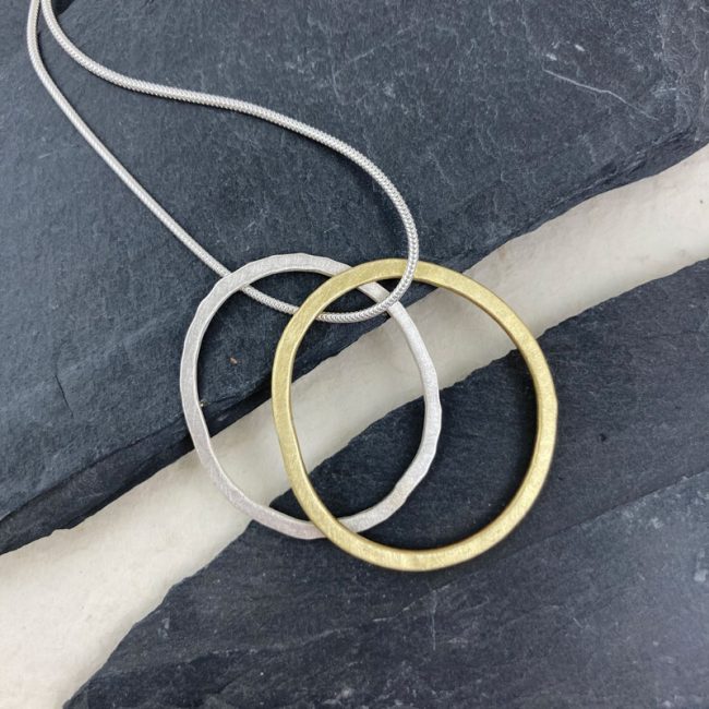 Silver and brass flat link pendants on silver snake chain by Samantha Maund