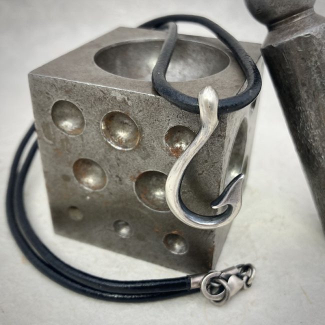Silver Hook necklace on black leather by Chris Hawkins