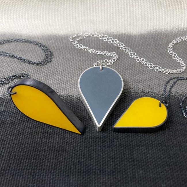 Resin and silver teardrop pendants in mustard & grey by Claire Lowe