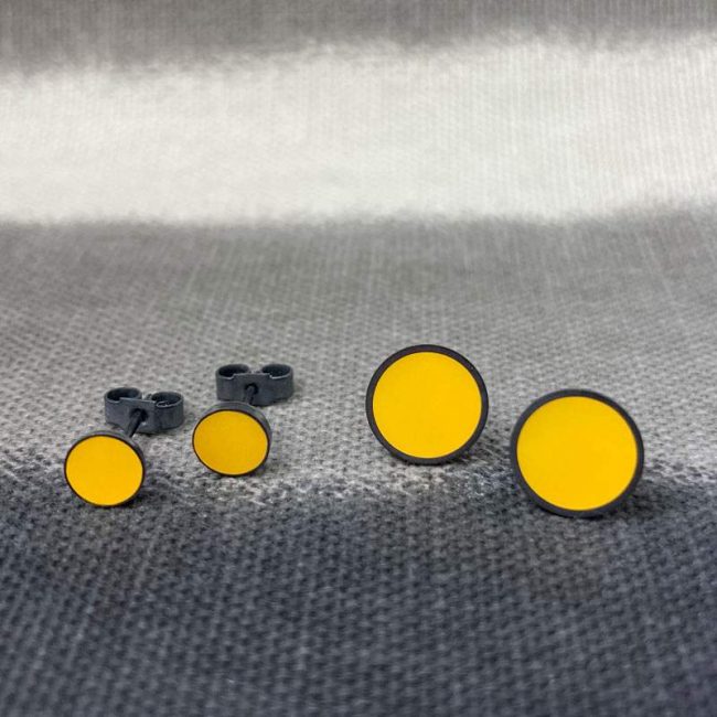 Mustard resin and oxidised silver circular stud earrings by Claire Lowe