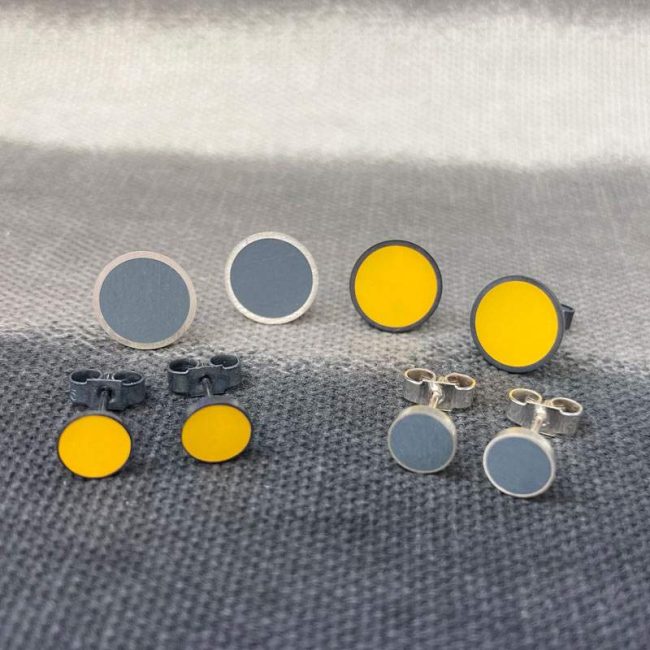 Resin and silver circular stud earrings in mustard & grey by Claire Lowe