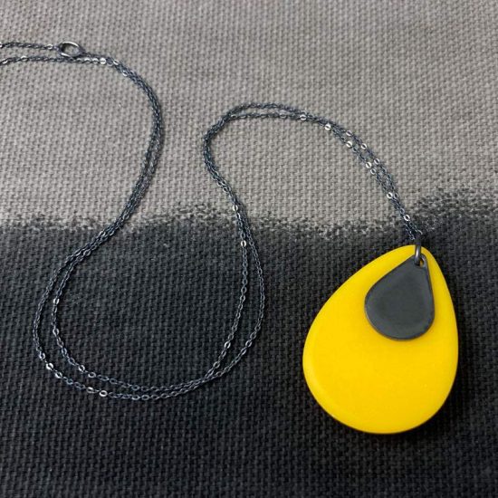 Domed mustard yellow resin and oxidised silver teardrop pendant by Claire Lowe