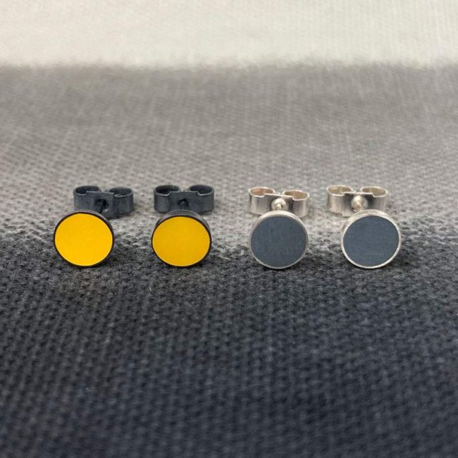 Tiny circular resin stud earrings in mustard & grey resin & silver by Claire Lowe