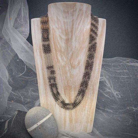 Interwoven chainmail necklace in titanium, silver and 9ct gold by Corrinne Eira Evans
