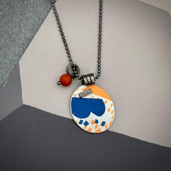 Pattern pendant in orange and navy blue by Lindsey Mann