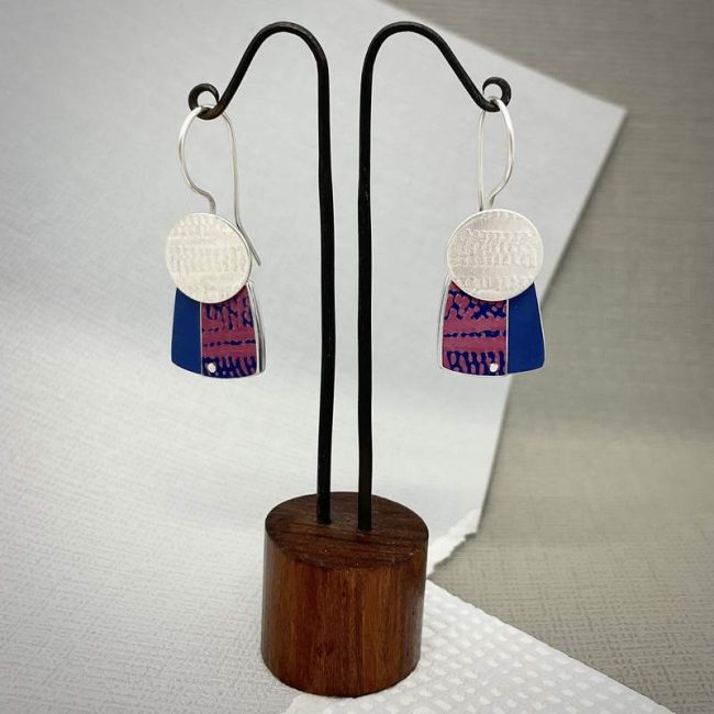 Trax silver oval drop earrings with pink and blue print on blue square by Penny Warren