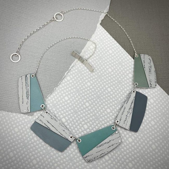 Trax large rectangular shapes necklace in greens and grey with white and grey print by Penny Warren