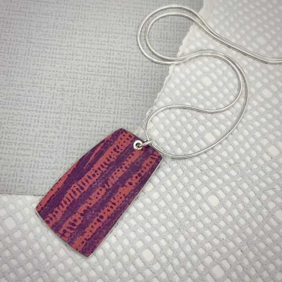 Trax large rectangular riveted pendant in berry and red by Penny Warren