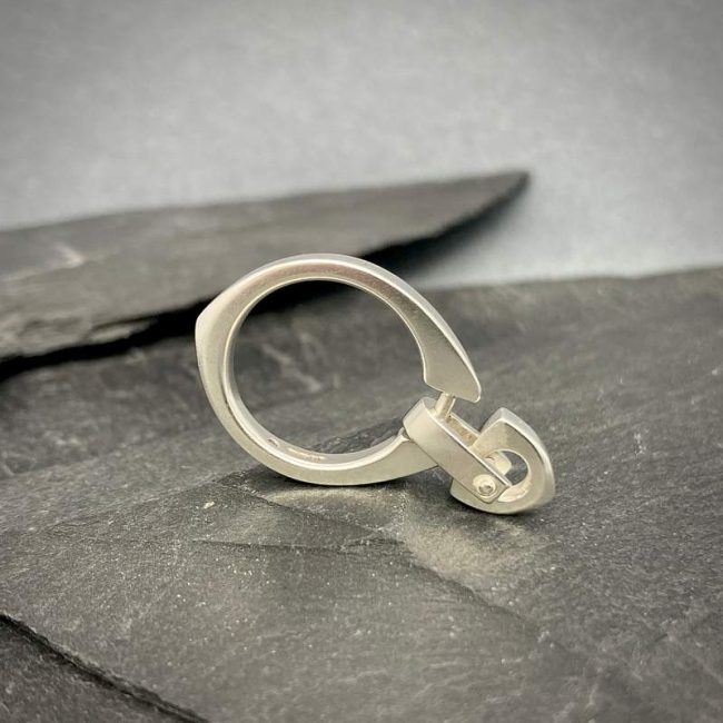 Idun carved silver ring with riveted logo bead by Annika Rutlin