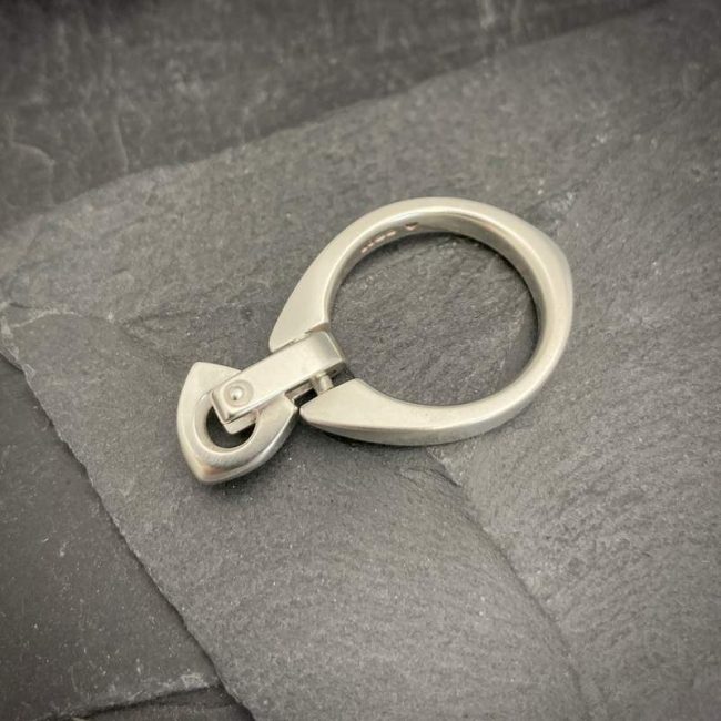 Idun carved silver ring with riveted logo bead by Annika Rutlin