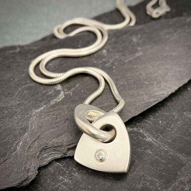 Idun large solid logo pendant set with 2.5mm white diamond by Annika Rutlin