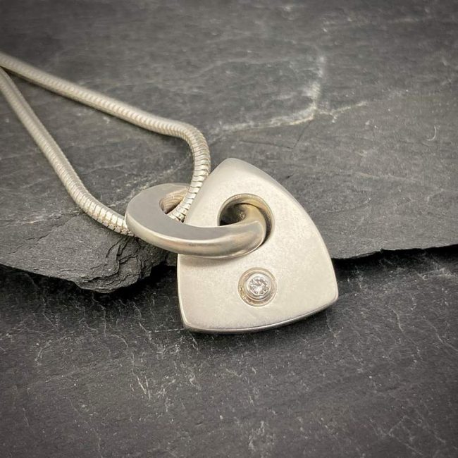 Idun large solid logo pendant set with 2.5mm white diamond by Annika Rutlin
