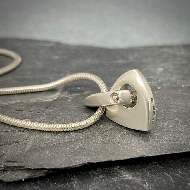 Idun small solid logo pendant in silver by Annika Rutlin
