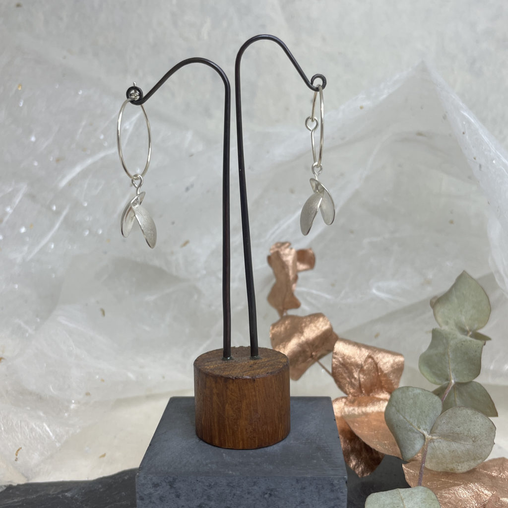 Long silver seed pod with outlets stone earring